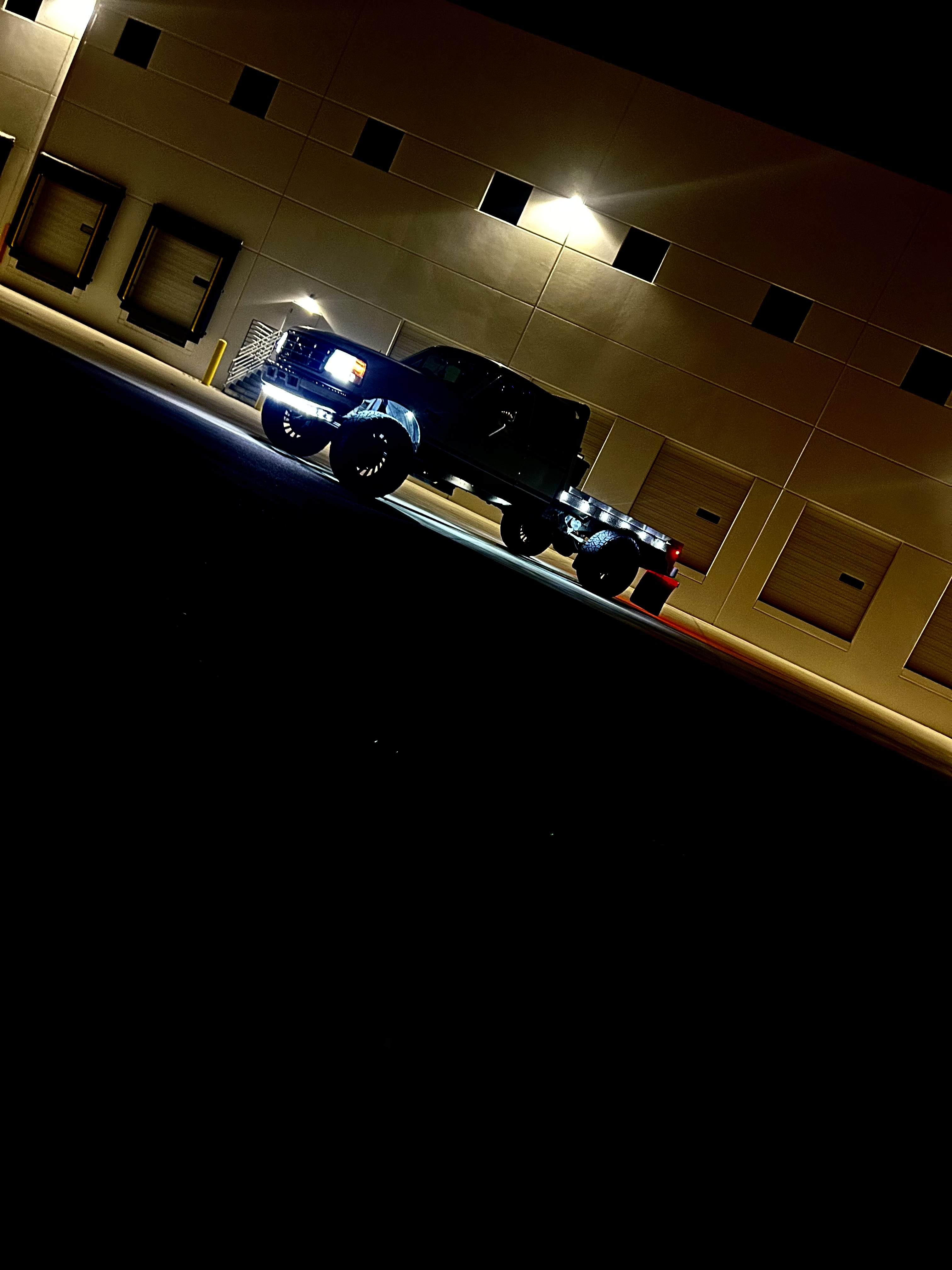 Night shot of lifted truck with underglow and custom lighting