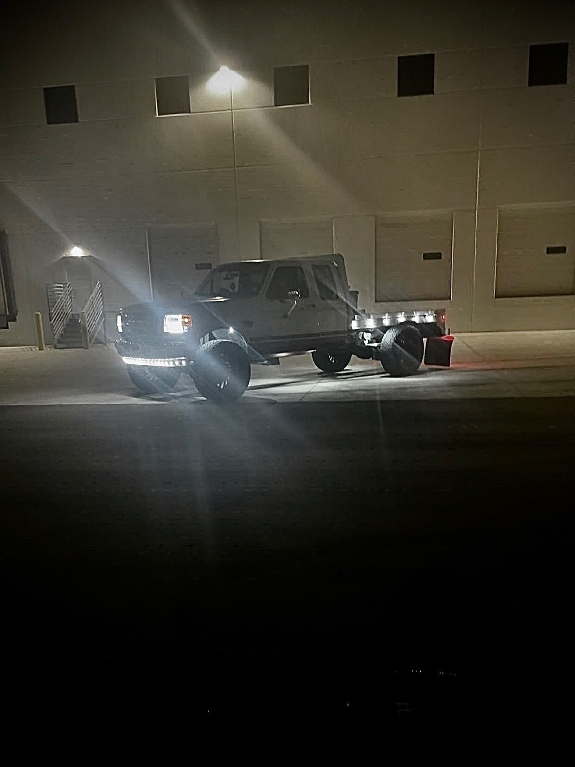 Custom lit flatbed truck parked at night