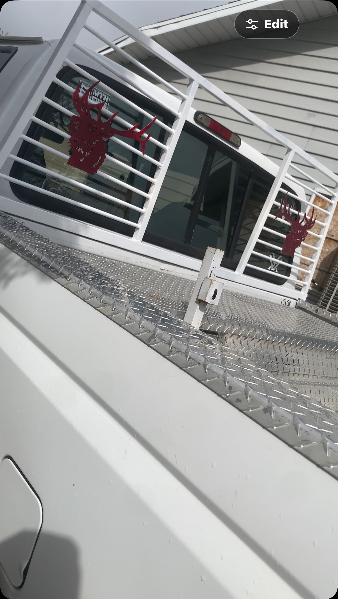 Custom white headache rack with red elk cutouts over diamond plate toolbox